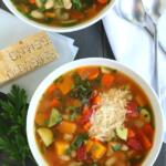 overhead view of autumn minestrone soup with spoons