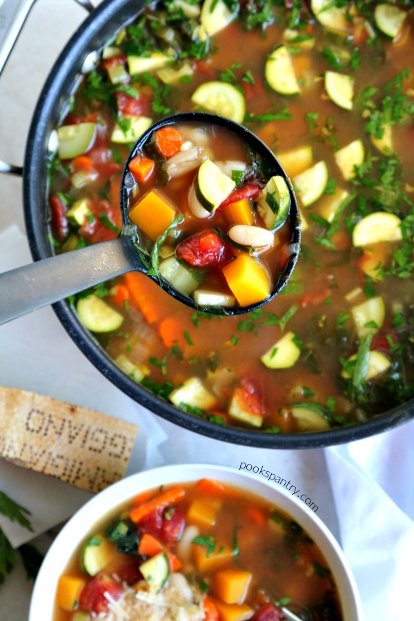 pot of autumn minestrone soup with ladle