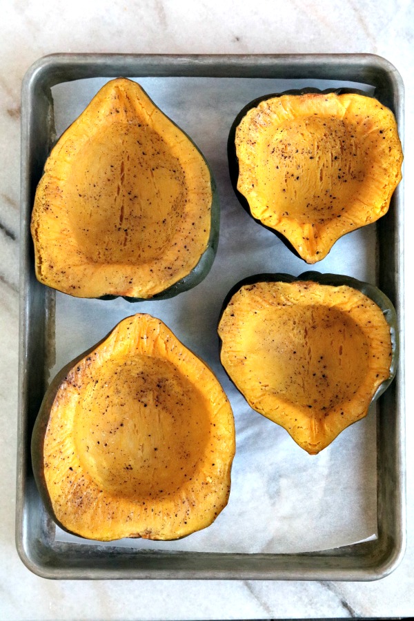 roasted acorn squash halves on sheet pan