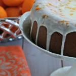 Clementine cake with glaze on cake stand.