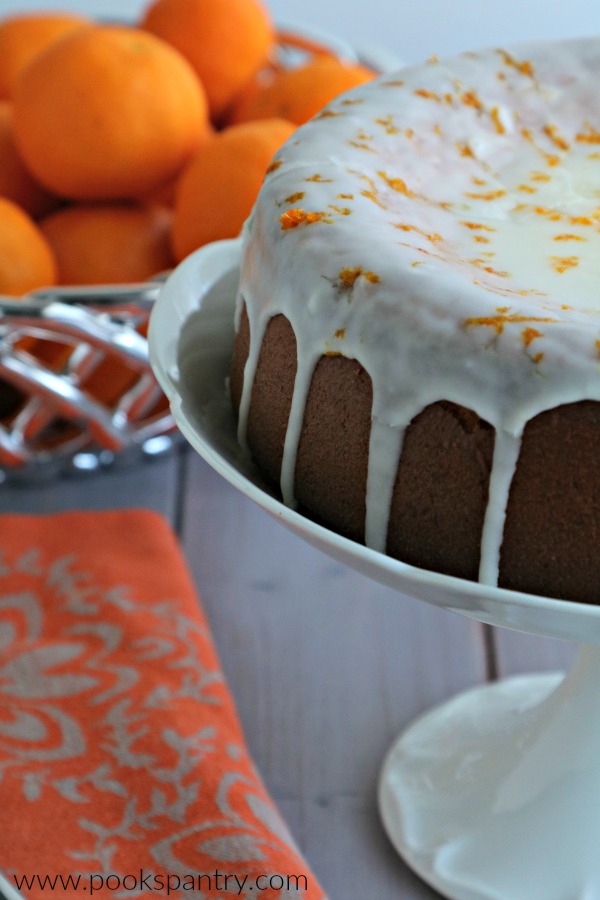 clementine cake with glaze on cake stand