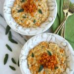two bowls of butternut squash risotto with gold forks