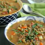 lentil soup in green and white bowl