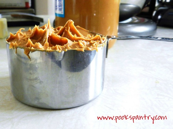 measuring peanut butter for homemade buckeyes