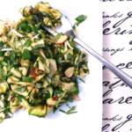 zucchini salad on white plate with fork