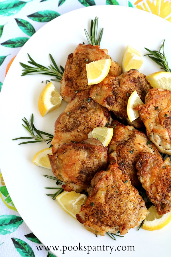 overhead shot of chicken thighs with lemon and rosemary