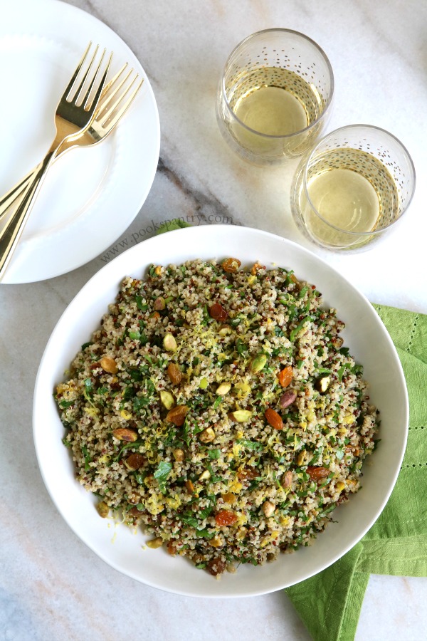 overhead view of quinoa salad with 2 wine glasses above bowl