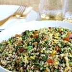 quinoa salad in bowl with gold forks in background