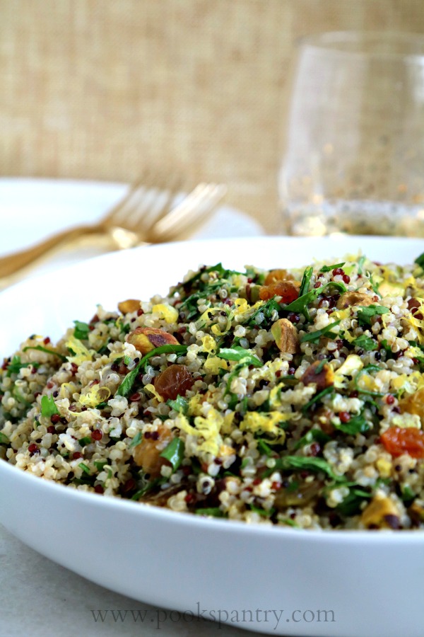 close up of quinoa salad with gold forks in background