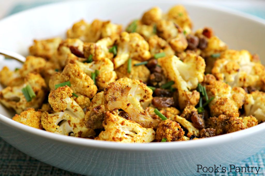 Curried Cauliflower with Golden Raisins and Ginger in white bowl