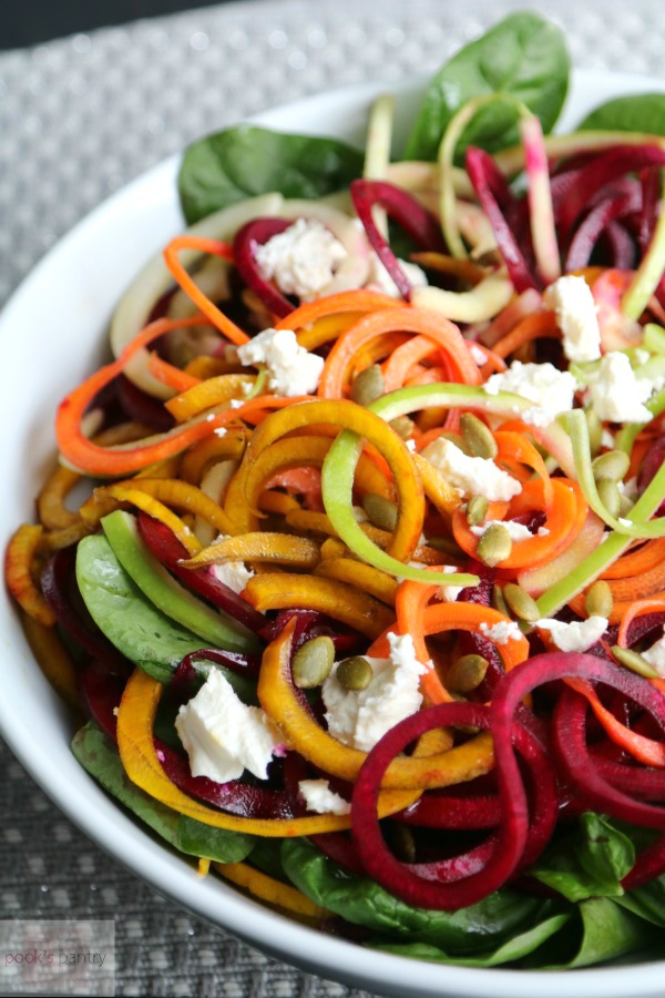 Beet, carrot and apple salad in large white bowl.