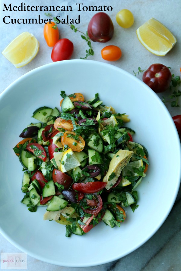 This Tomato Cucumber Salad Recipe is a great way to use up your end of summer bounty. As summer comes to an end, tomatoes and cucumbers are plentiful and this salad celebrates all the flavors of the season. With ripe heirloom tomatoes, seedless English cucumber, kalamata olives, marinated artichokes and a burst of lemon, this salad is the perfect summer side or light lunch.