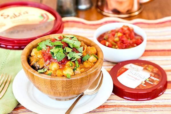 chickpea chili in wooden bowl on white plate