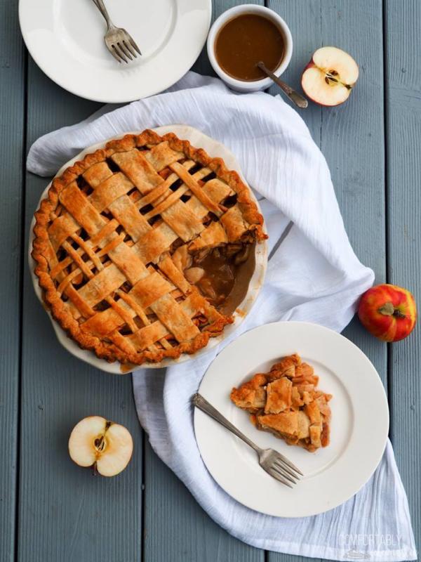 caramel apple pie with white plates and apples