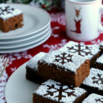Squares of gingerbread cake with a snowflake pattern on top.