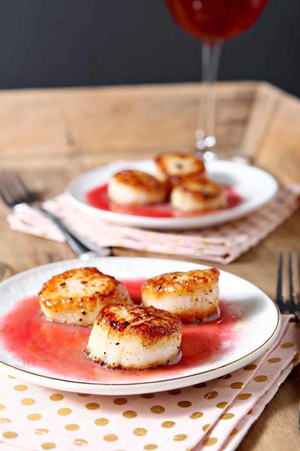 scallops with raspberry gastrique on plate with polka dot napkin
