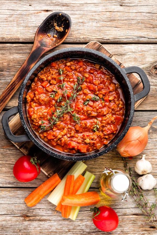 pot of vegetable bolognese on wood background