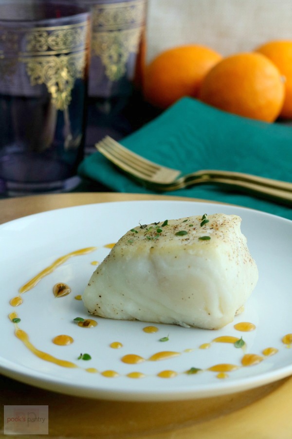 seared halibut on white plate with sauce