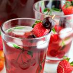 strawberry cherry spritzer in glass with cherries on it