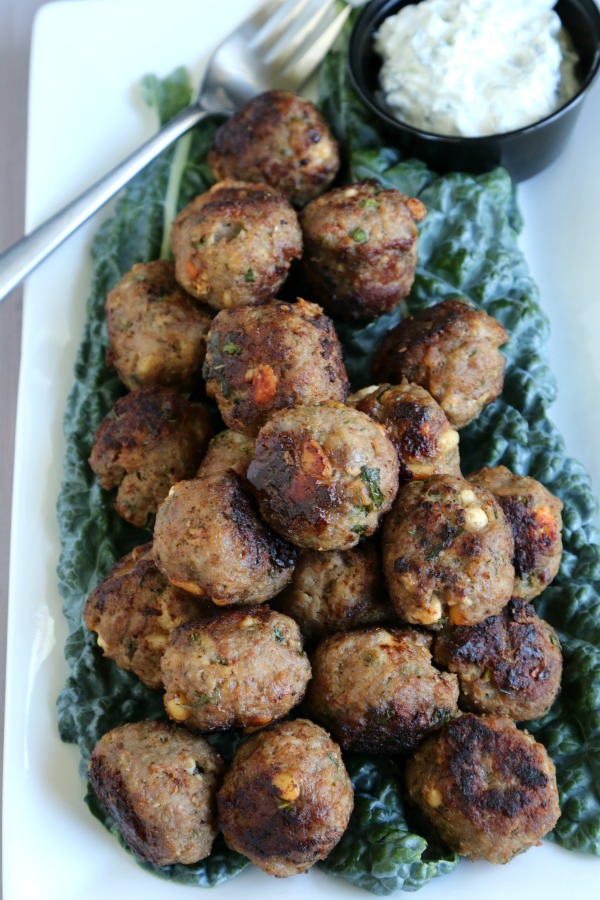 mediterranean meal prep lamb meatballs on white platter with fork