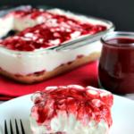 no bake strawberry cheesecake slice on plate with fork