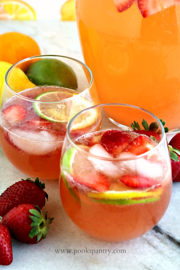 strawberry sangria in clear stemless glass with fruit garnish