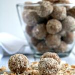 coconut rum balls on bed of toasted coconut
