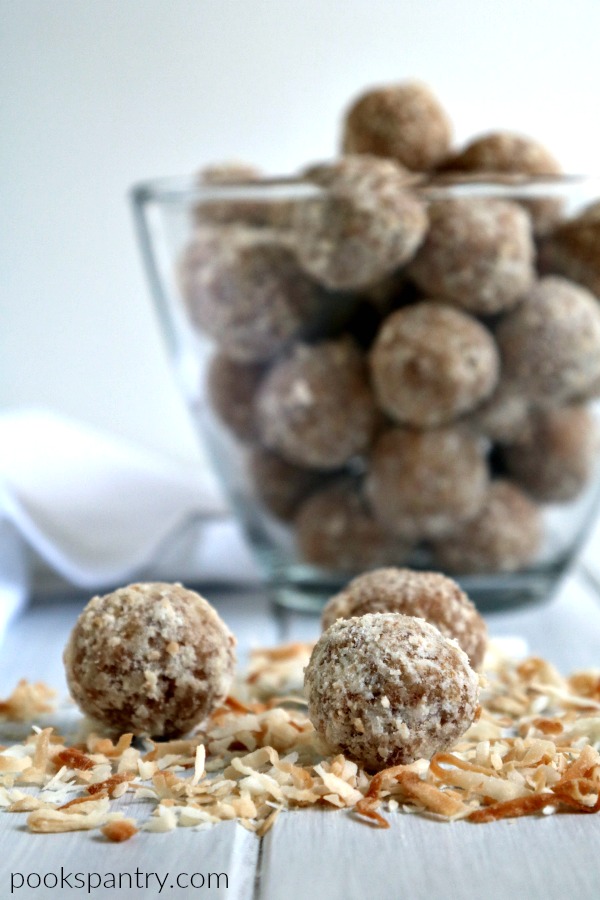 coconut rum balls on bed of toasted coconut