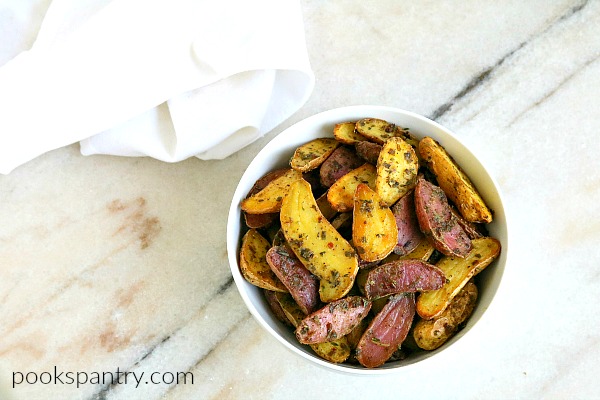 bowl of baked fingerling potatoes with white cloth