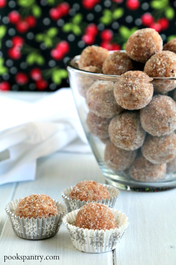 cherry rum balls in muffin papers with bowl of rum balls in background