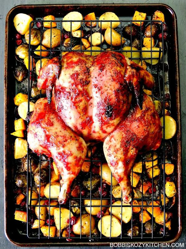 spatch cocked chicken on sheet pan with cranberry glaze