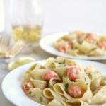 langostino pasta on white plate with gold fork