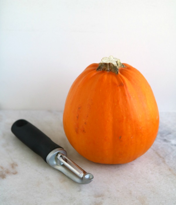 sugar pumpkin with vegetable peeler