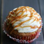 Cupcake in red and white paper with caramel drizzle.