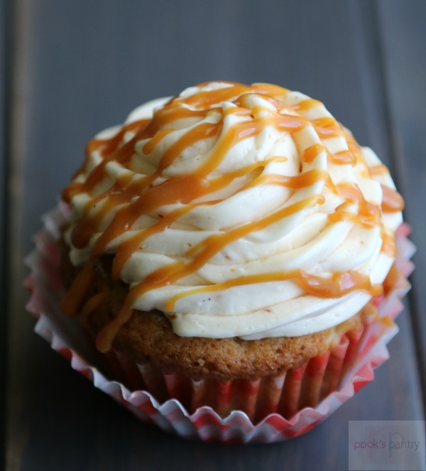cupcakes in red and white paper with caramel drizzle