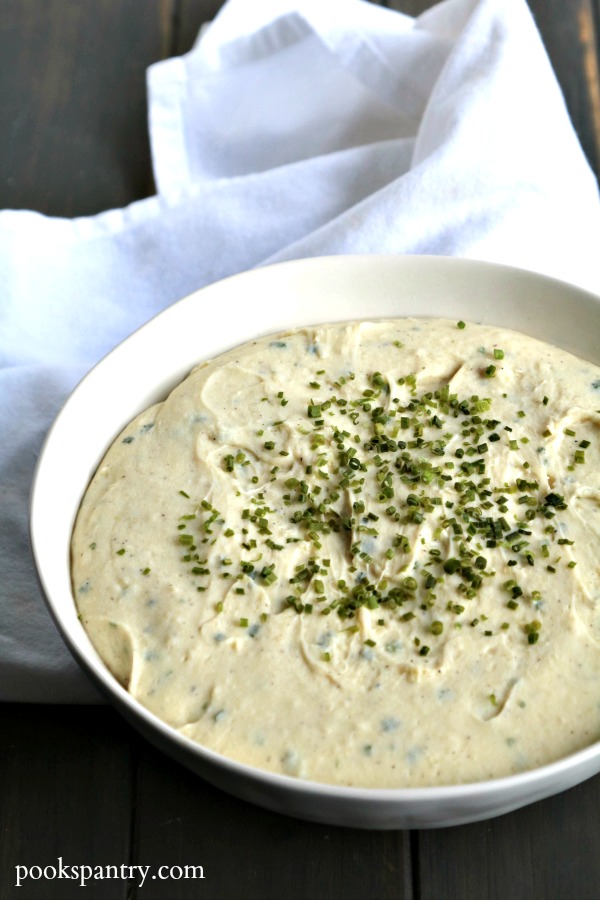 aligot potatoes in white bowl with chives