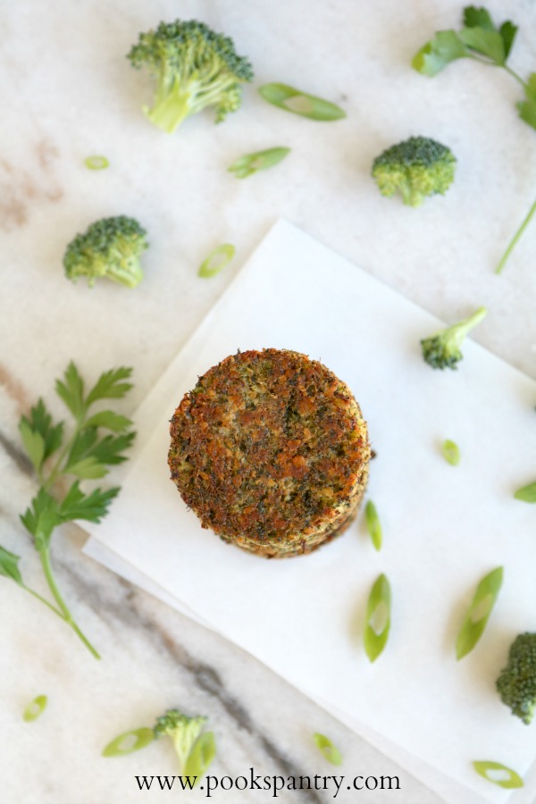 overhead view of baked broccoli cake with herbs