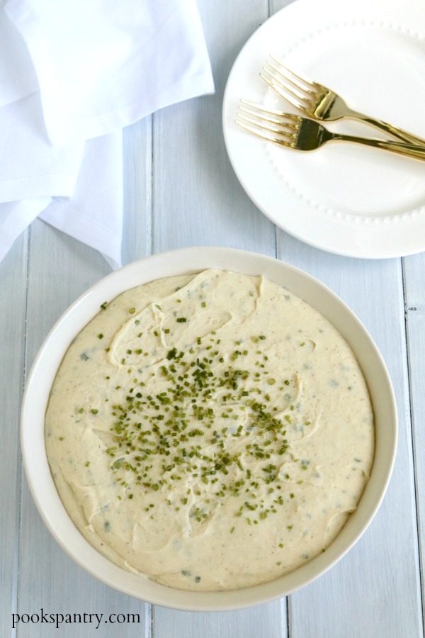 bowl of cheesy mashed potatoes with chives