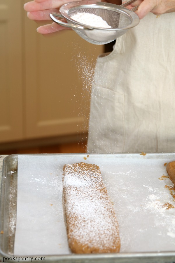 dusting biscotti with powdered sugar