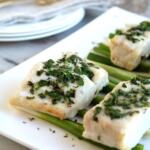 corvina with butter and herbs on white platter