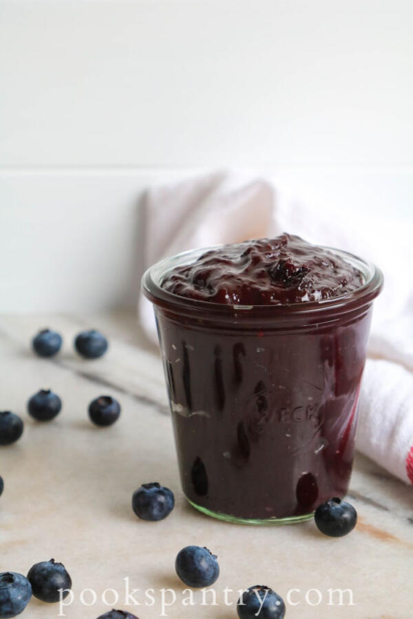 blueberry bourbon BBQ sauce in glass jar with blueberries