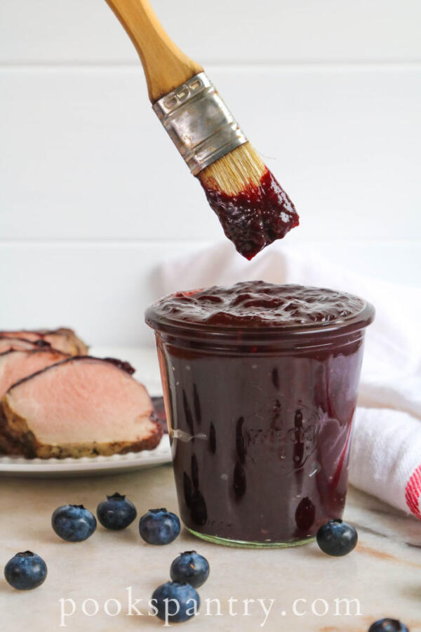 blueberry bourbon barbecue sauce with brush in jar