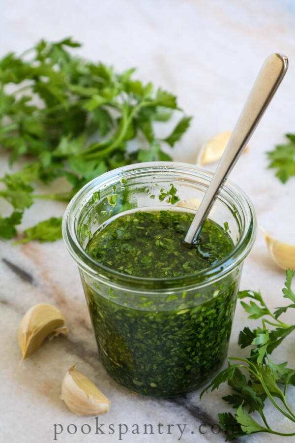 gremolata sauce in glass jar with spoon