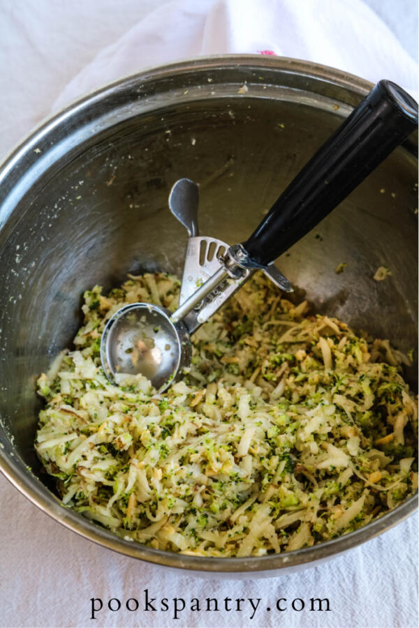 shredded potatoes and broccoli in bowl with scoop