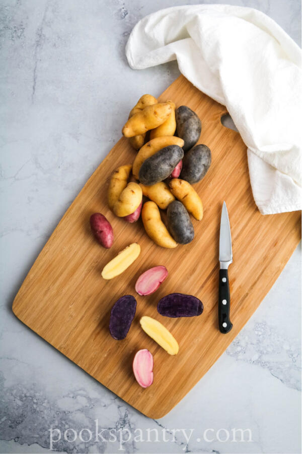 garlic fingerling potatoes on cutting board with knife