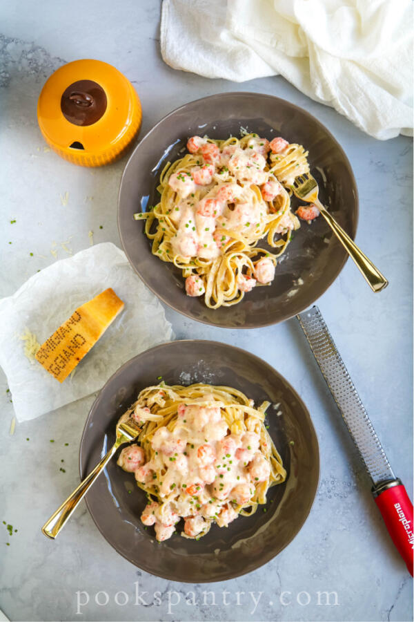 overhead shot of langostino cream sauce with pasta in bowls