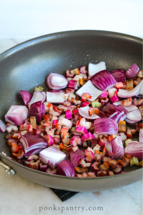red onion and Swiss chard in pan for Italian bread salad