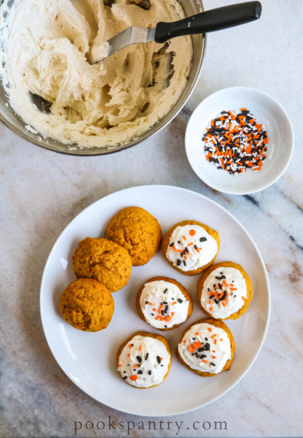 frosted pumpkin cookies on plate