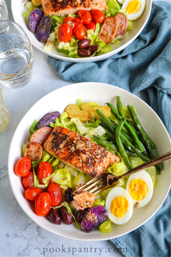 salmon meal prep bowl with vegetables in white bowl