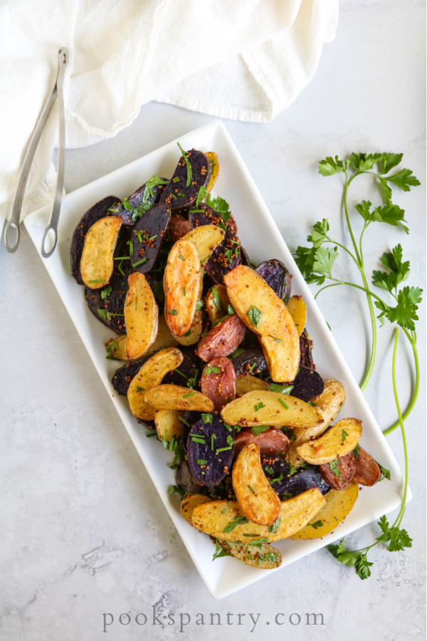 duck fat fingerling potato recipe on white plate with herbs
